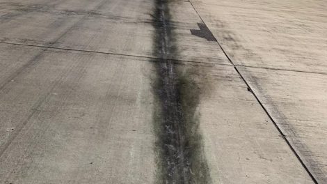 Scratch marks with oil leak visible on the runway at Karachi's Jinnah International Airport.