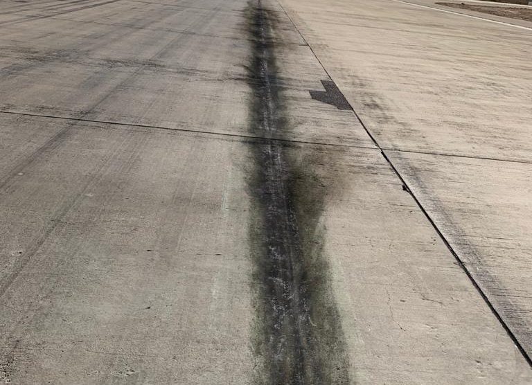 Scratch marks with oil leak visible on the runway at Karachi's Jinnah International Airport.